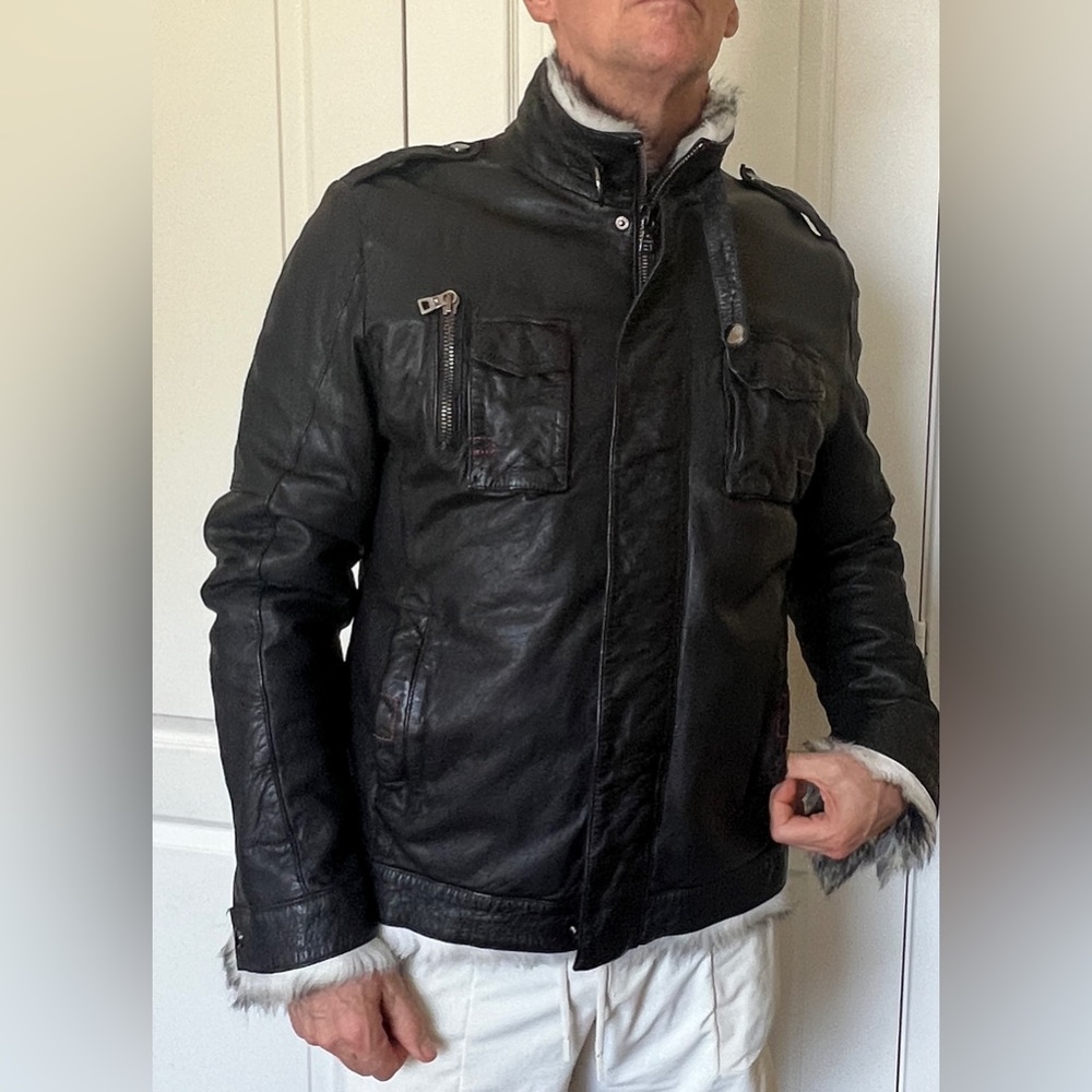 Stunning leather jacket with grey/black/white fur lining.